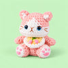 Blossom Bloom Kitty: a blush pink kitten with bright blue eyes and a floral bib