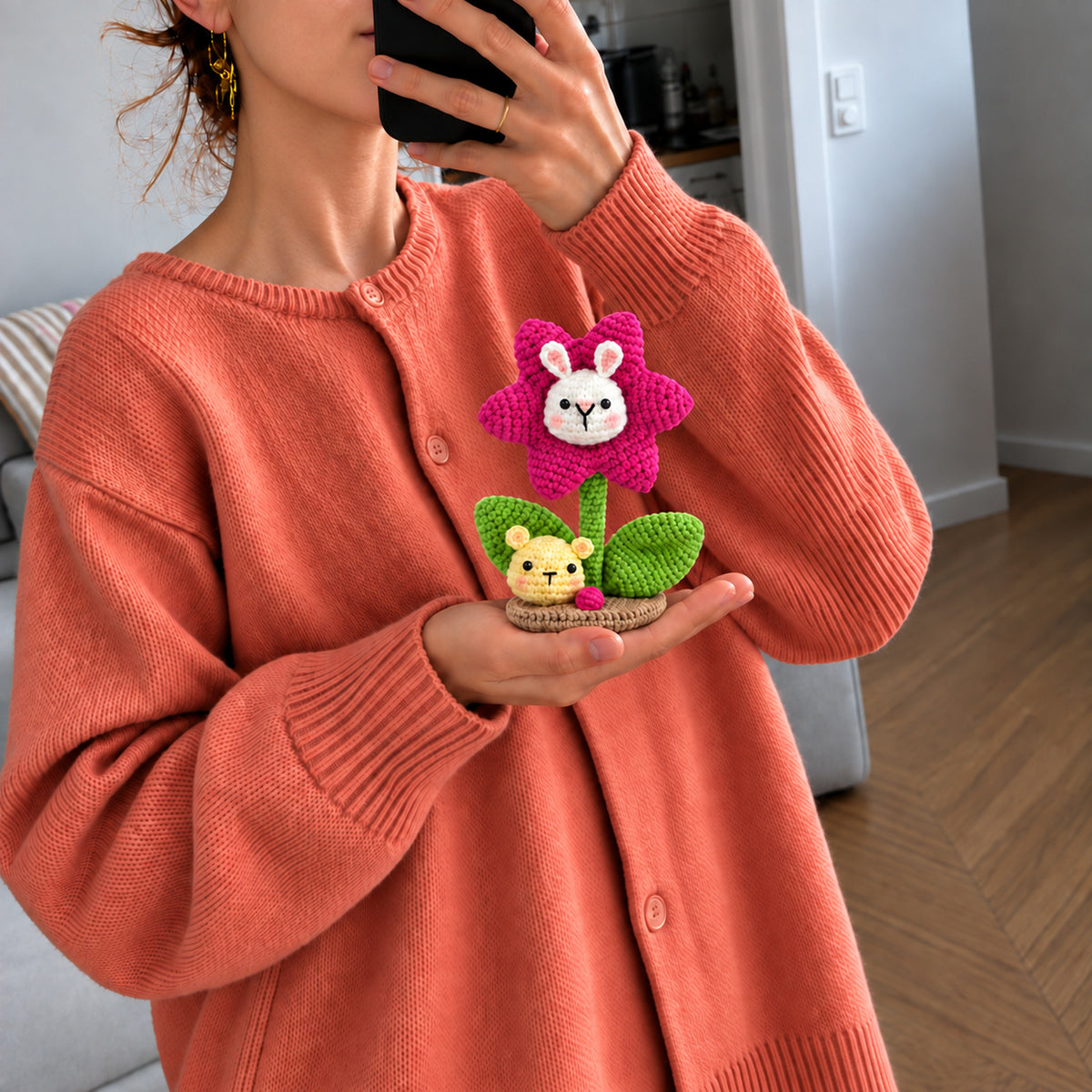 Bunny Bloom: a pink bunny-faced flower with a tiny bear detail, shown in hand