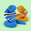 Cobra Charm Duo: blue and ochre cobras with striped markings and rounded faces