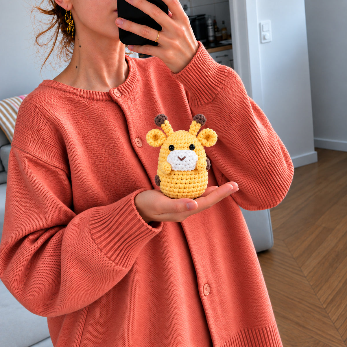 Honey Giraffe: a golden yellow giraffe with small brown horns and a gentle face, shown in hand