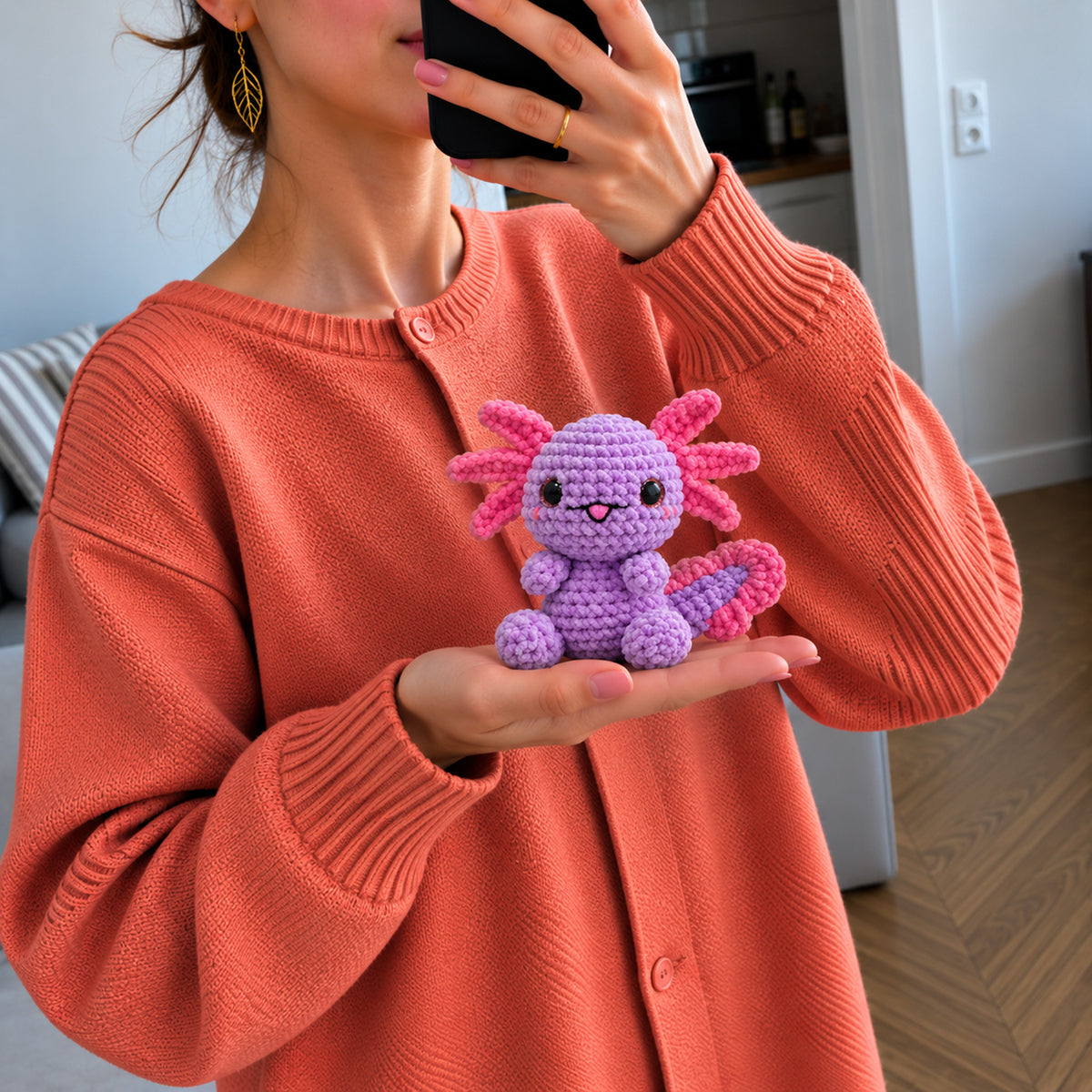 Lilac Axolotl: a lilac axolotl with pink gills and bright dark eyes, shown in hand
