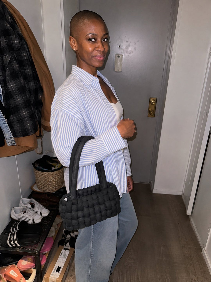 Crafter wearing a handmade black crochet bag