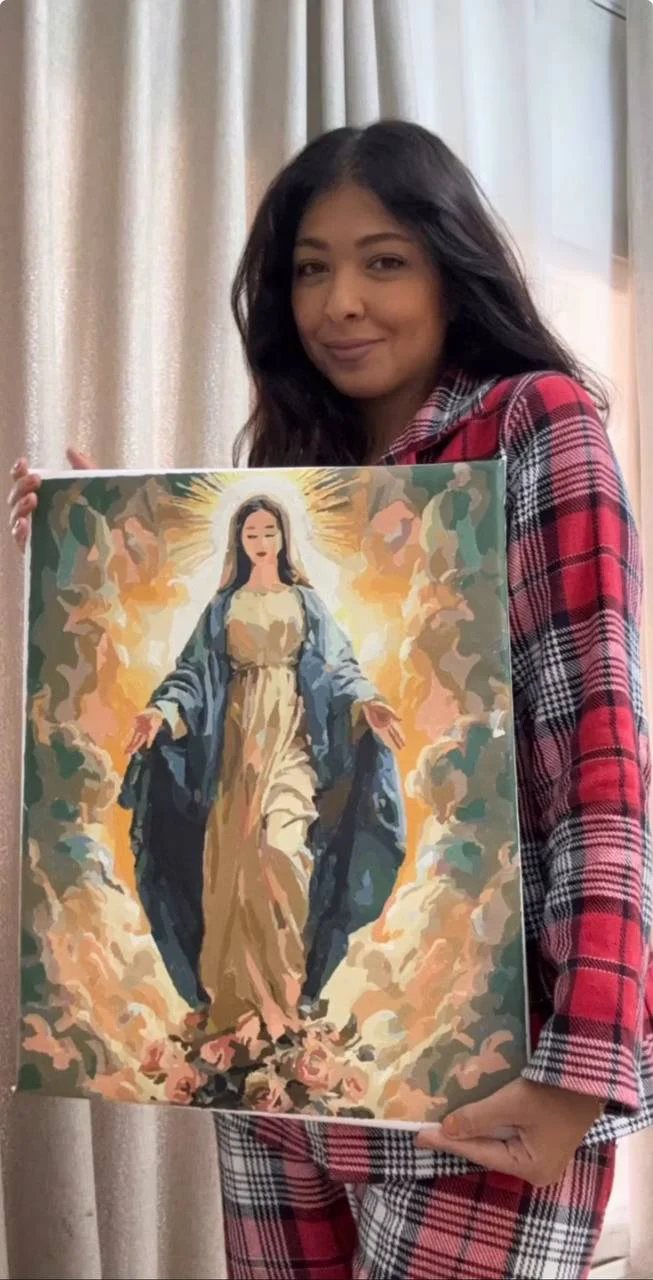Crafter standing with a large finished artwork