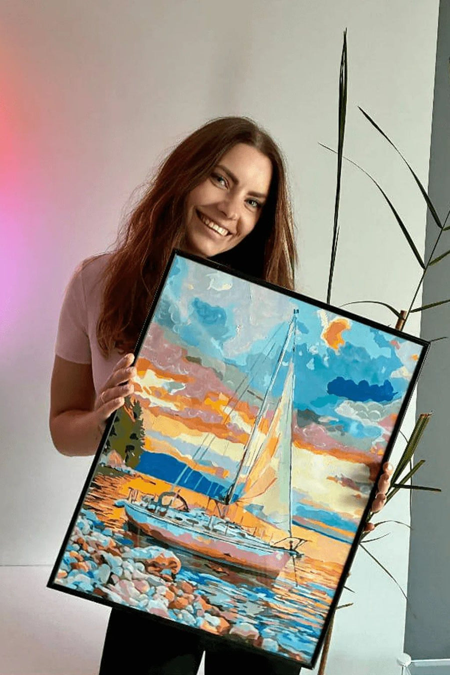 Crafter holding a seaside painting