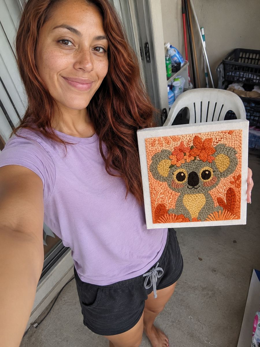 Crafter holding a framed koala artwork