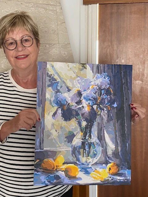 Crafter holding a large iris painting