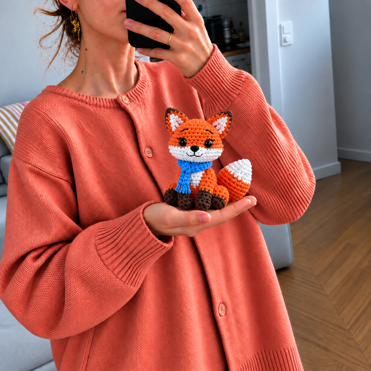 Autumn Scarf Fox: an orange fox wrapped in a bright blue scarf, shown in hand