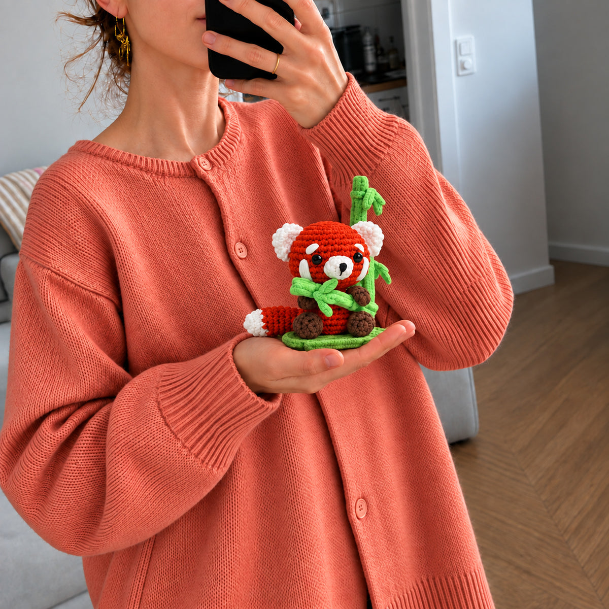 Bamboo Red Panda: a red panda holding a little green bamboo sprig, shown in hand