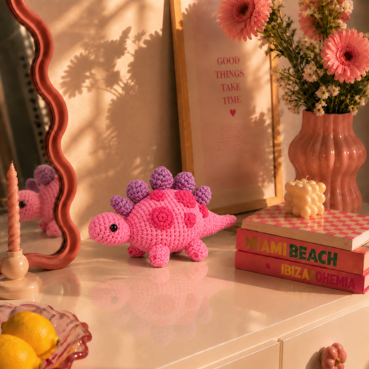 Berry Little Dino: a berry pink dinosaur with purple plates along its back, displayed in an interior setting