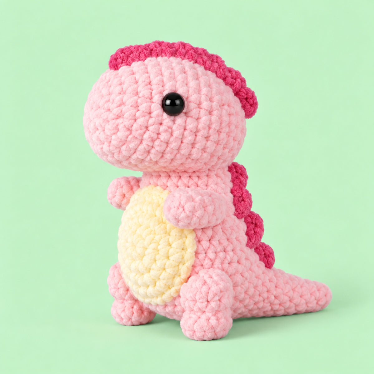 Blossom Little Dino: a pink standing dinosaur with a cream belly