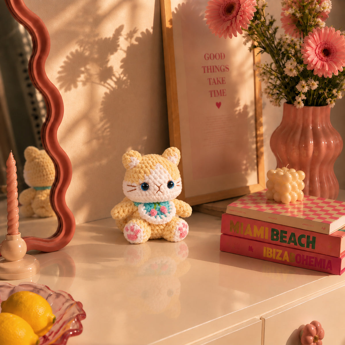 Buttercup Bloom Kitty: a golden yellow kitten with bright blue eyes and a little floral bib, displayed in an interior setting