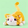Buttercup Stretch Cat: a yellow striped cat stretching its paws and curling its tail