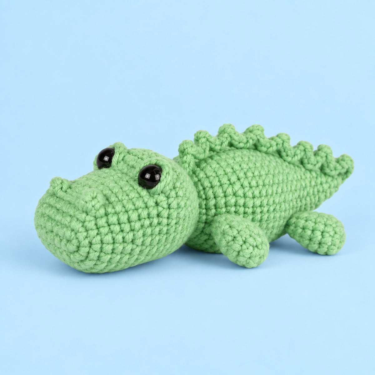 Clover Crocodile: a green crocodile with a rounded snout and a row of small back scales