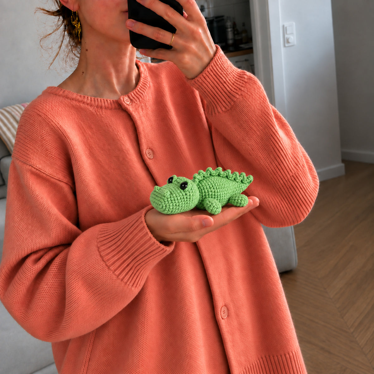 Clover Crocodile: a green crocodile with a rounded snout and a row of small back scales, shown in hand