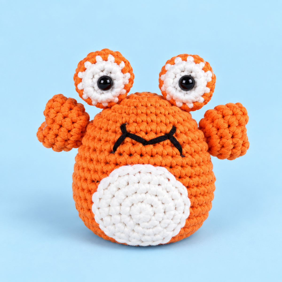 Coral Pop Crab: an orange crab with tall eyes and small raised claws
