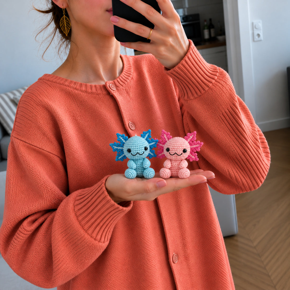 Cotton Candy Axolotls: pink and blue axolotls with delicate frilly gills, shown in hand