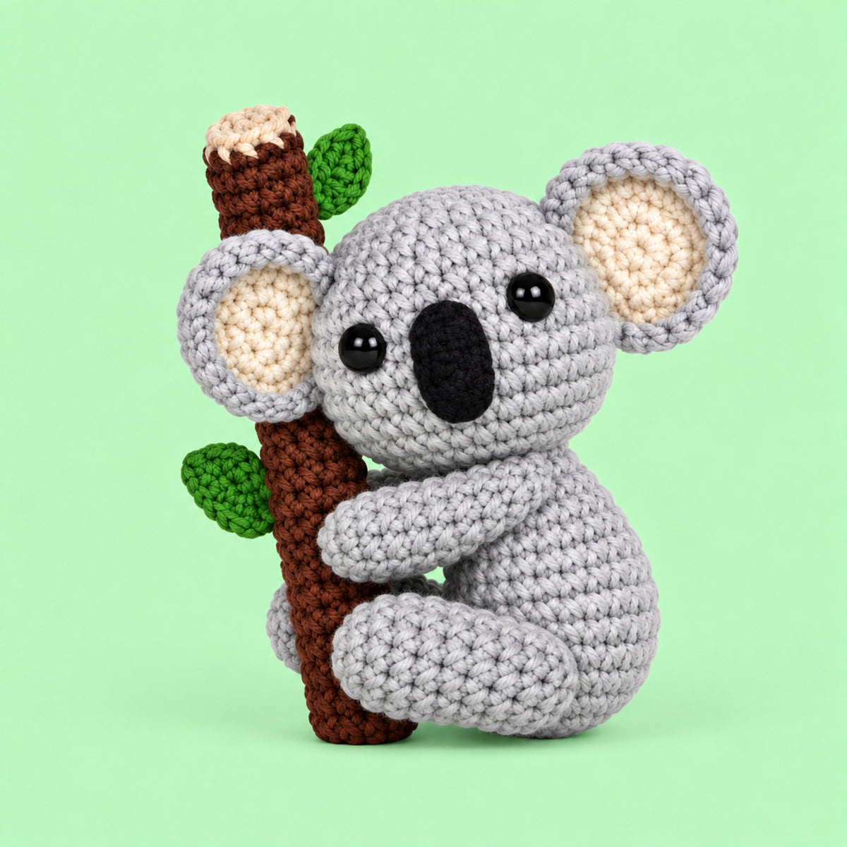 Eucalyptus Koala: a grey koala holding onto a little leafy branch