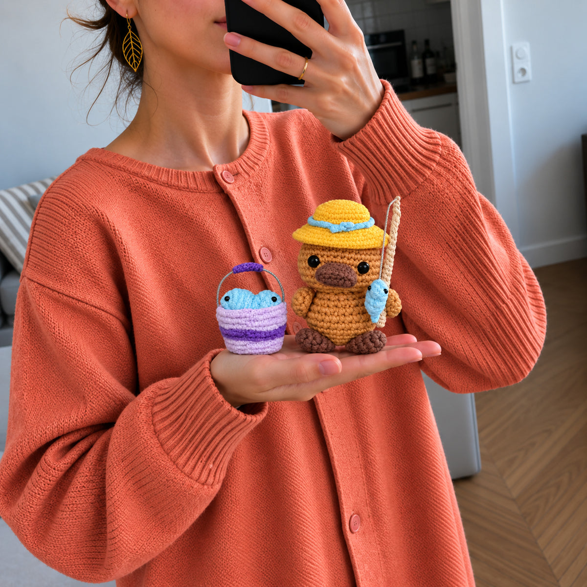 Gone Fishing Platypus: a platypus in a yellow hat with a small fish and bucket, shown in hand