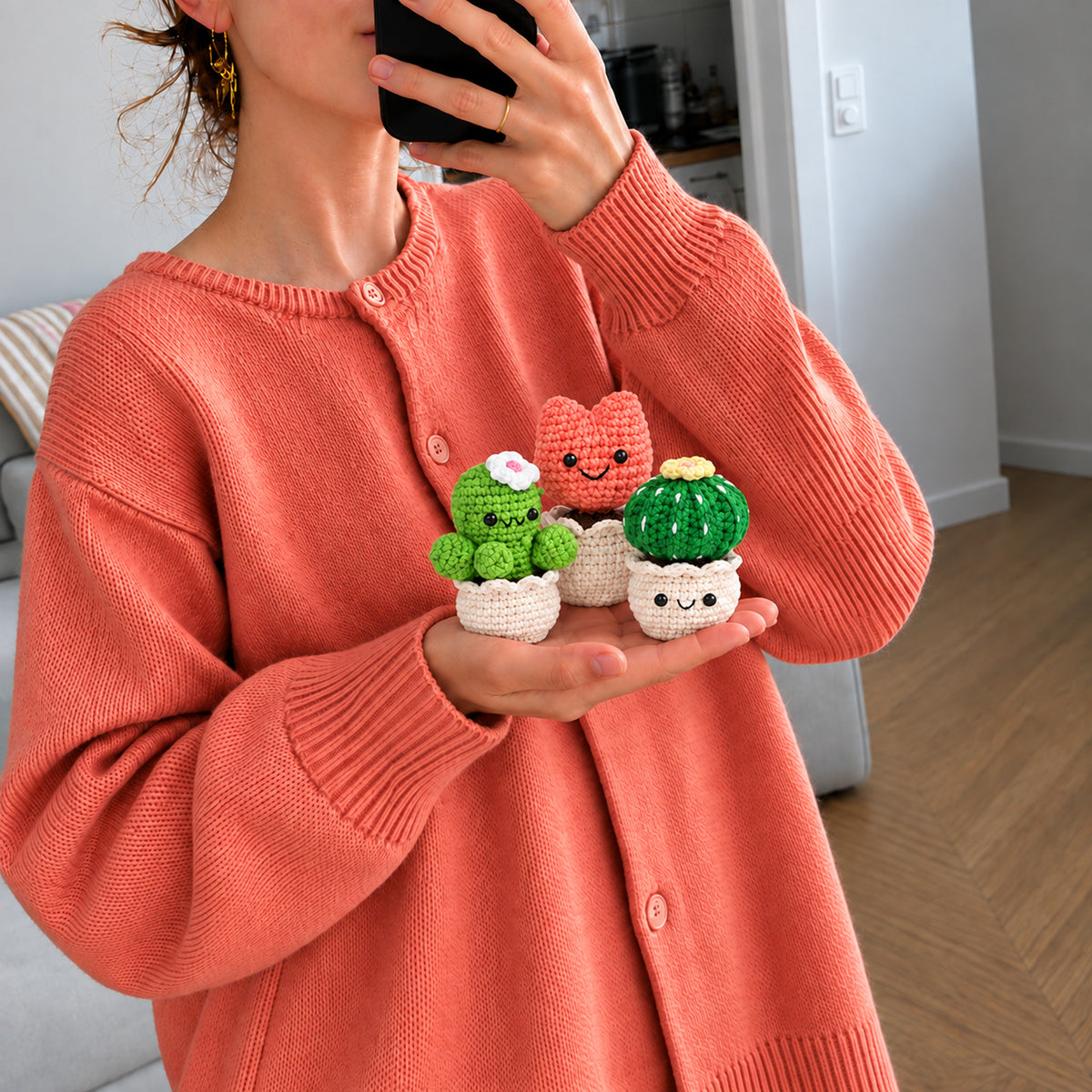 Happy Windowsill Trio: smiling plants in small white pots, shown in hand