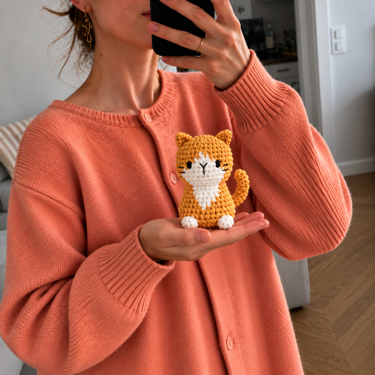 Honey Tabby: a honey-coloured cat with a white chest and a curled tail, shown in hand