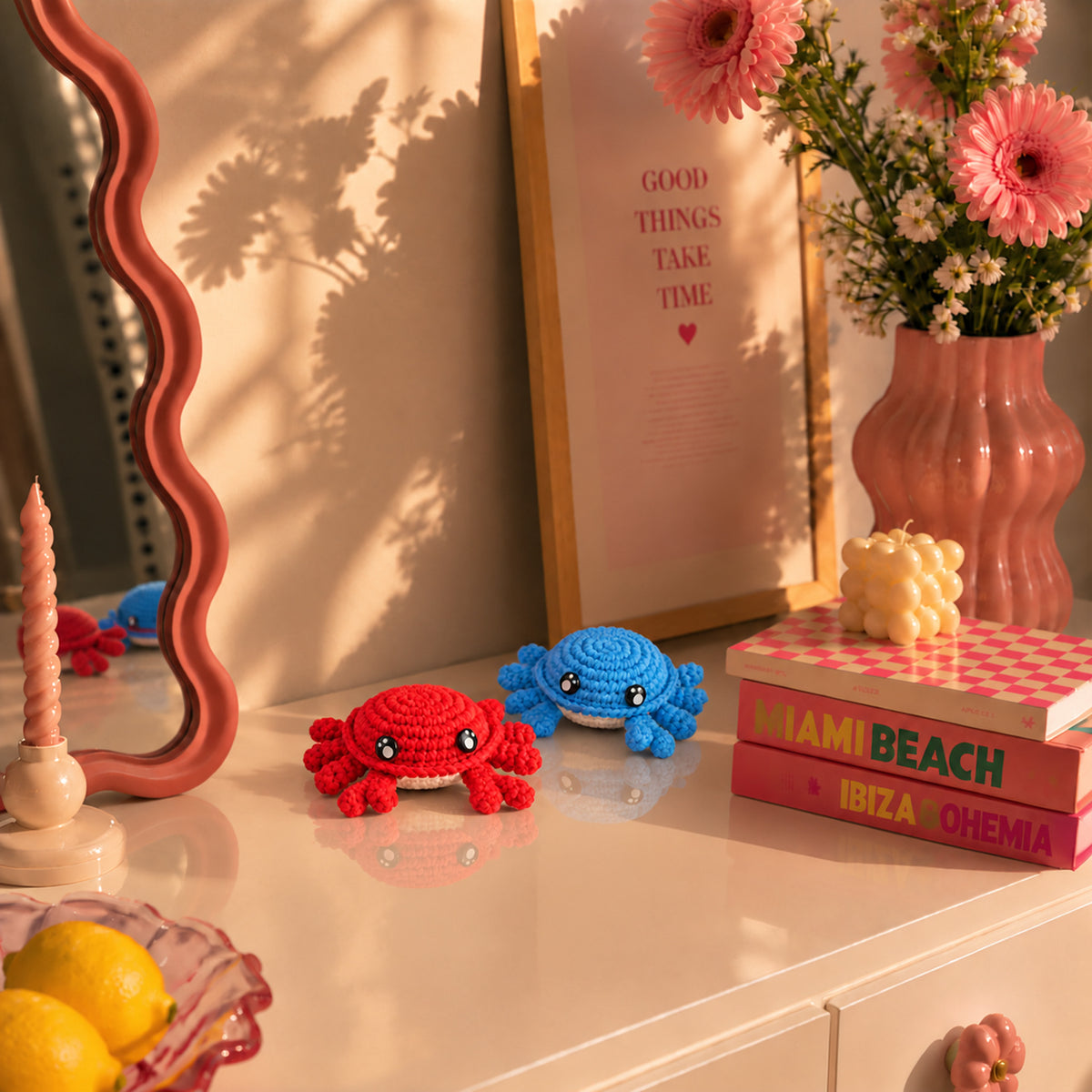 Little Tide Crab Duo: red and blue crabs with rounded bodies and small legs, displayed in an interior setting