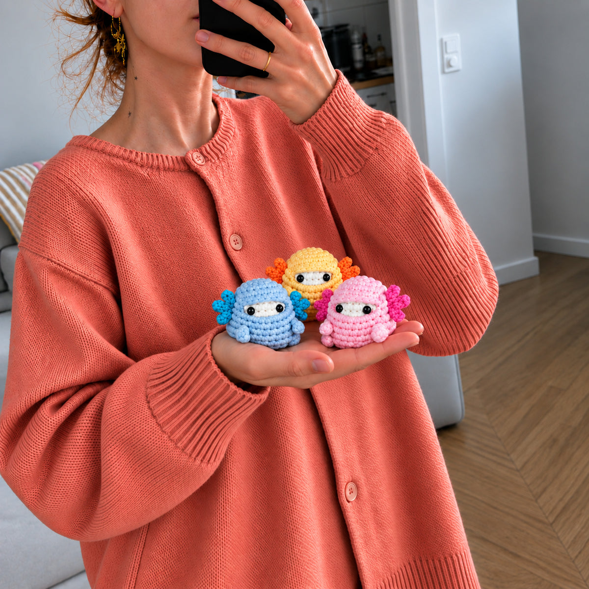 Marshmallow Axolotl Crew: blue, yellow and pink axolotls, shown in hand
