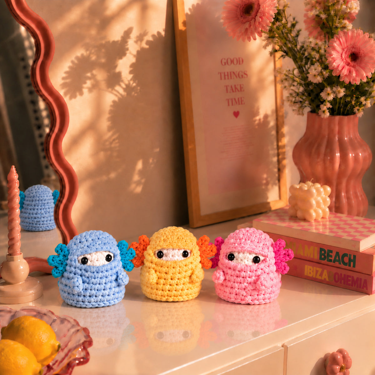 Marshmallow Axolotl Crew: blue, yellow and pink axolotls, displayed in an interior setting