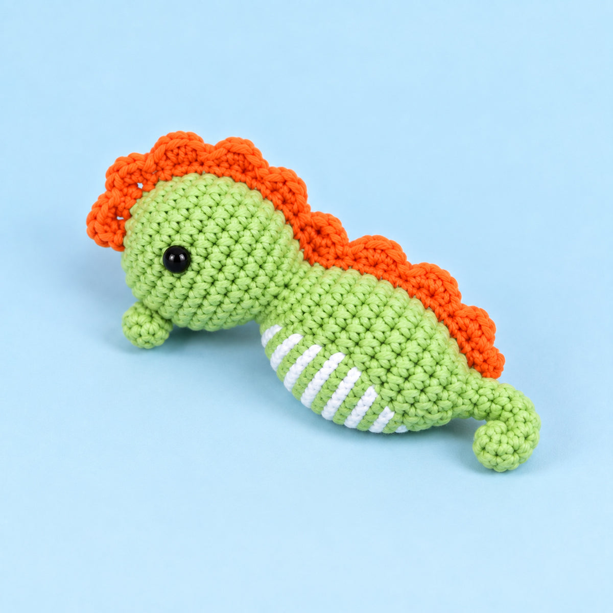 Meadow Seahorse: a green seahorse with an orange crest and curved tail