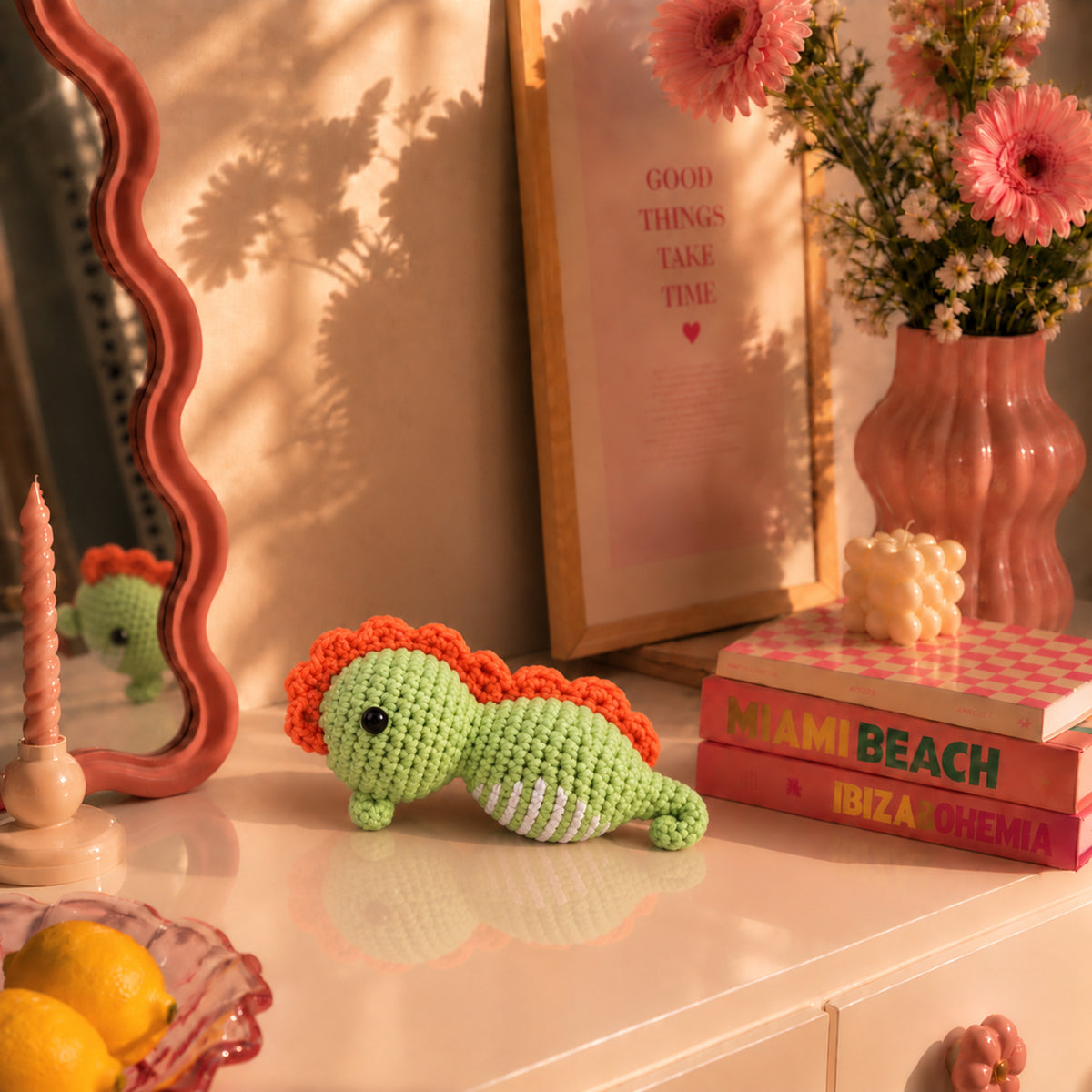 Meadow Seahorse: a green seahorse with an orange crest and curved tail, displayed in an interior setting