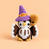 Moonspell Owl: a wide-eyed owl in a purple witch hat, complete with a little broom