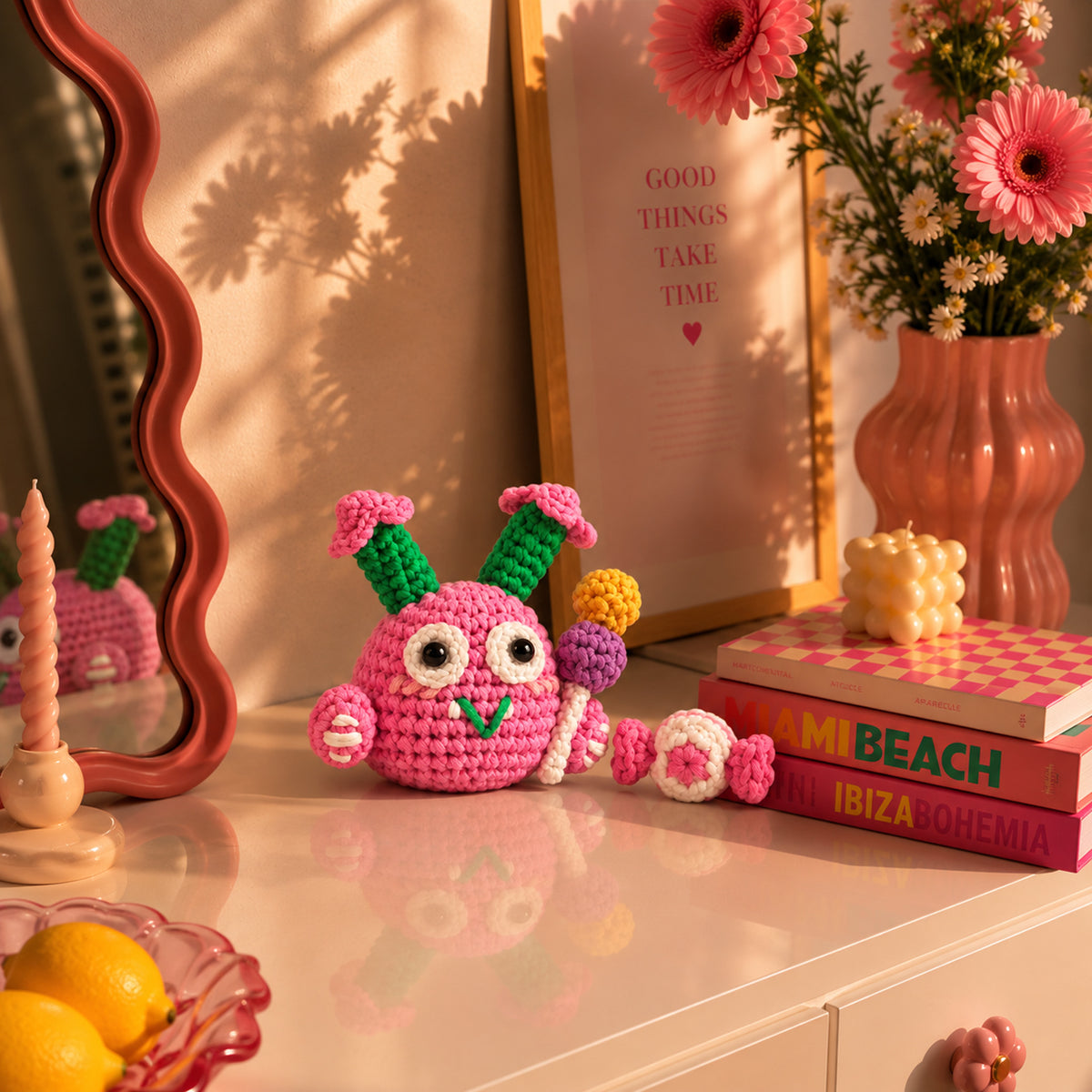 Petal Pop Monster: a pink round monster with colourful flower details, displayed in an interior setting