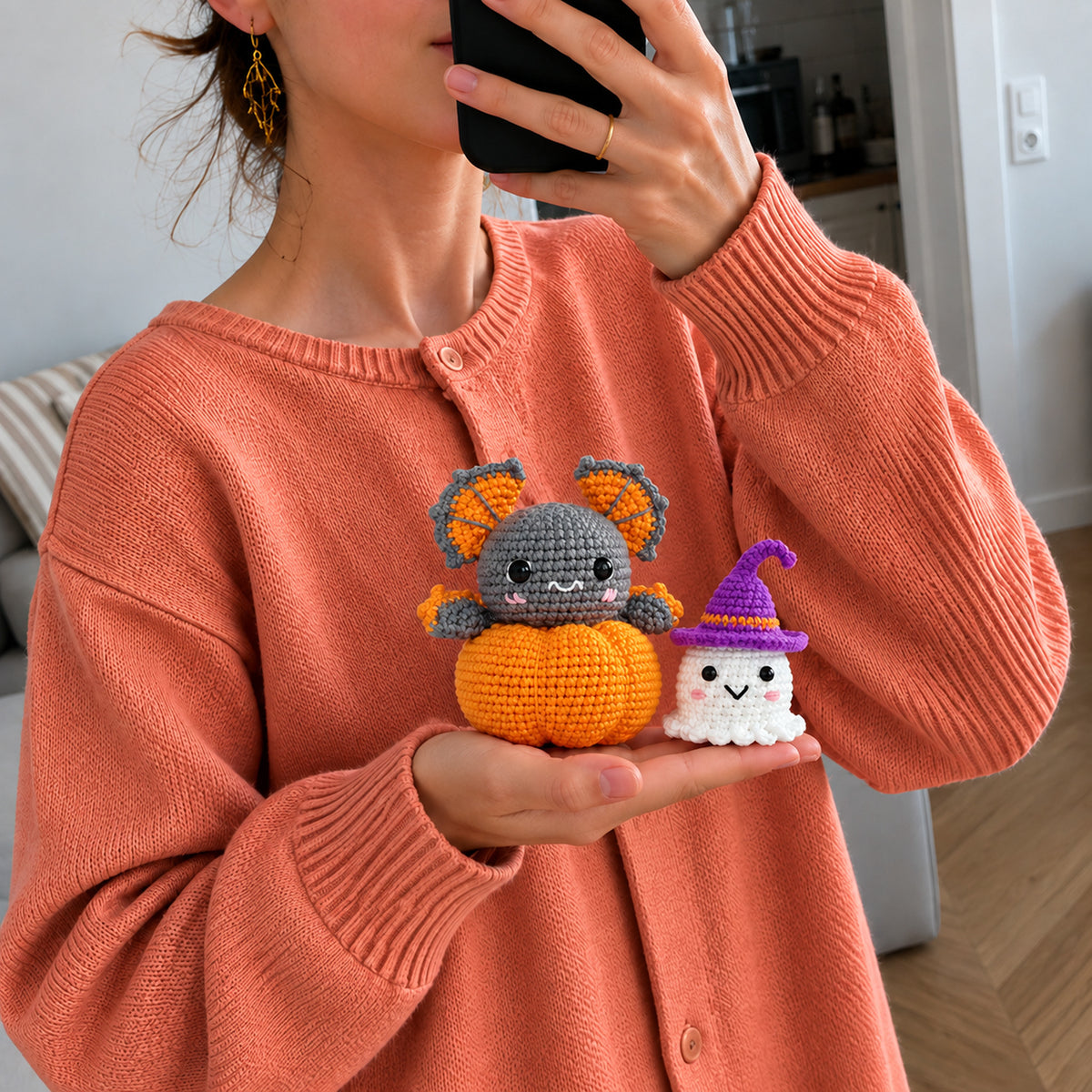 Pumpkin Moon Friends: a grey bat peeking from a pumpkin alongside a little witch ghost, shown in hand