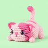 Rosebud Stretch Cat: a pink striped cat stretching its paws and curling its tail