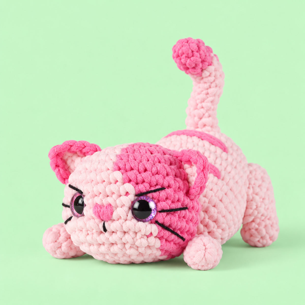 Rosebud Stretch Cat: a pink striped cat stretching its paws and curling its tail