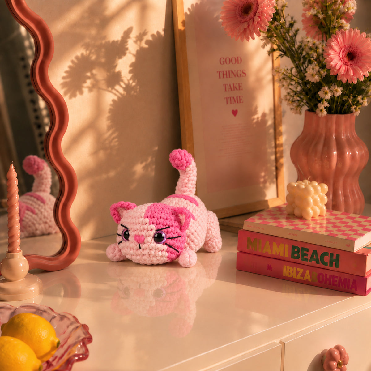 Rosebud Stretch Cat: a pink striped cat stretching its paws and curling its tail, displayed in an interior setting