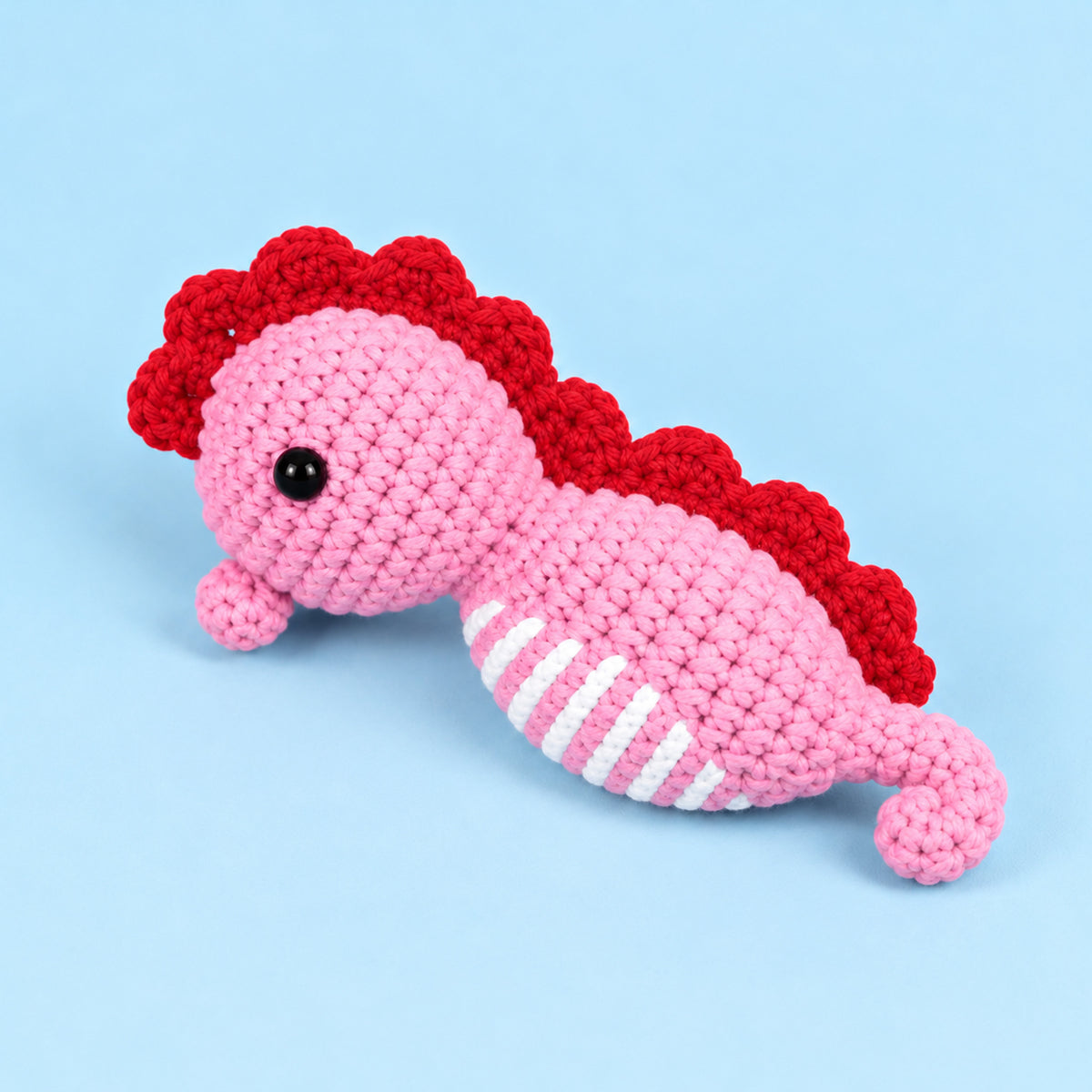 Rosy Seahorse: a pink seahorse with a deep rose crest and curved tail
