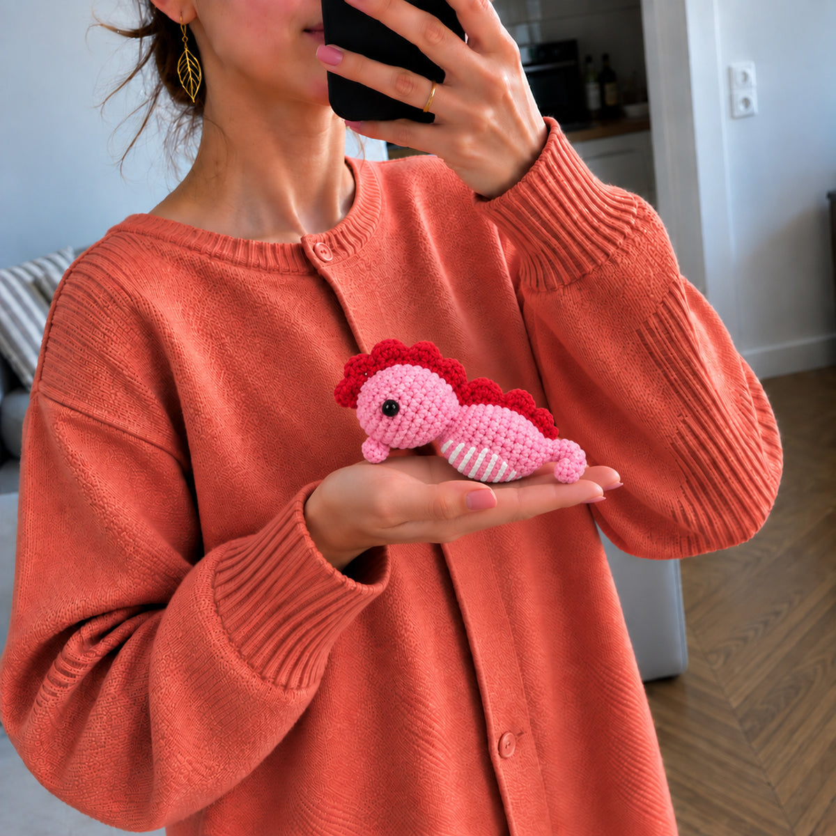 Rosy Seahorse: a pink seahorse with a deep rose crest and curved tail, shown in hand