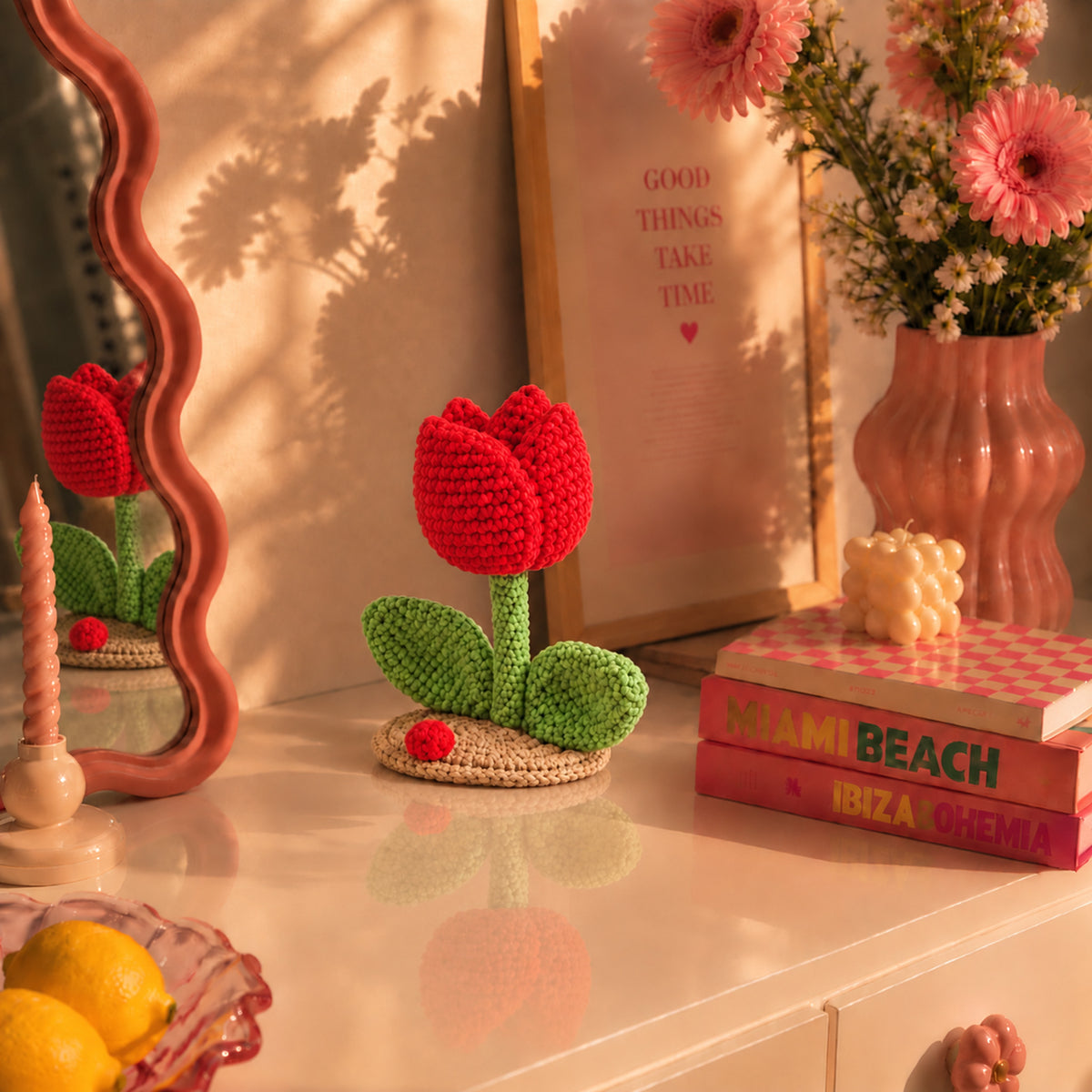 Ruby Tulip: a red tulip with green leaves on a small base, displayed in an interior setting