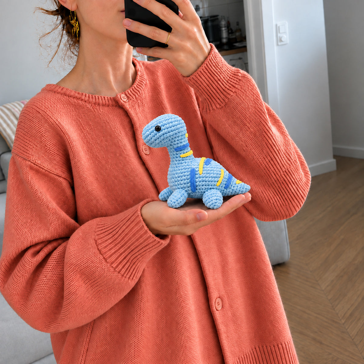 Sky Blue Longneck: a blue long-neck dinosaur with yellow stripes, shown in hand