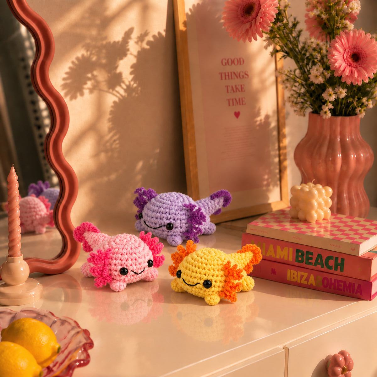 Sorbet Axolotl Trio: pink, lilac and yellow axolotls with tiny frilly gills, displayed in an interior setting