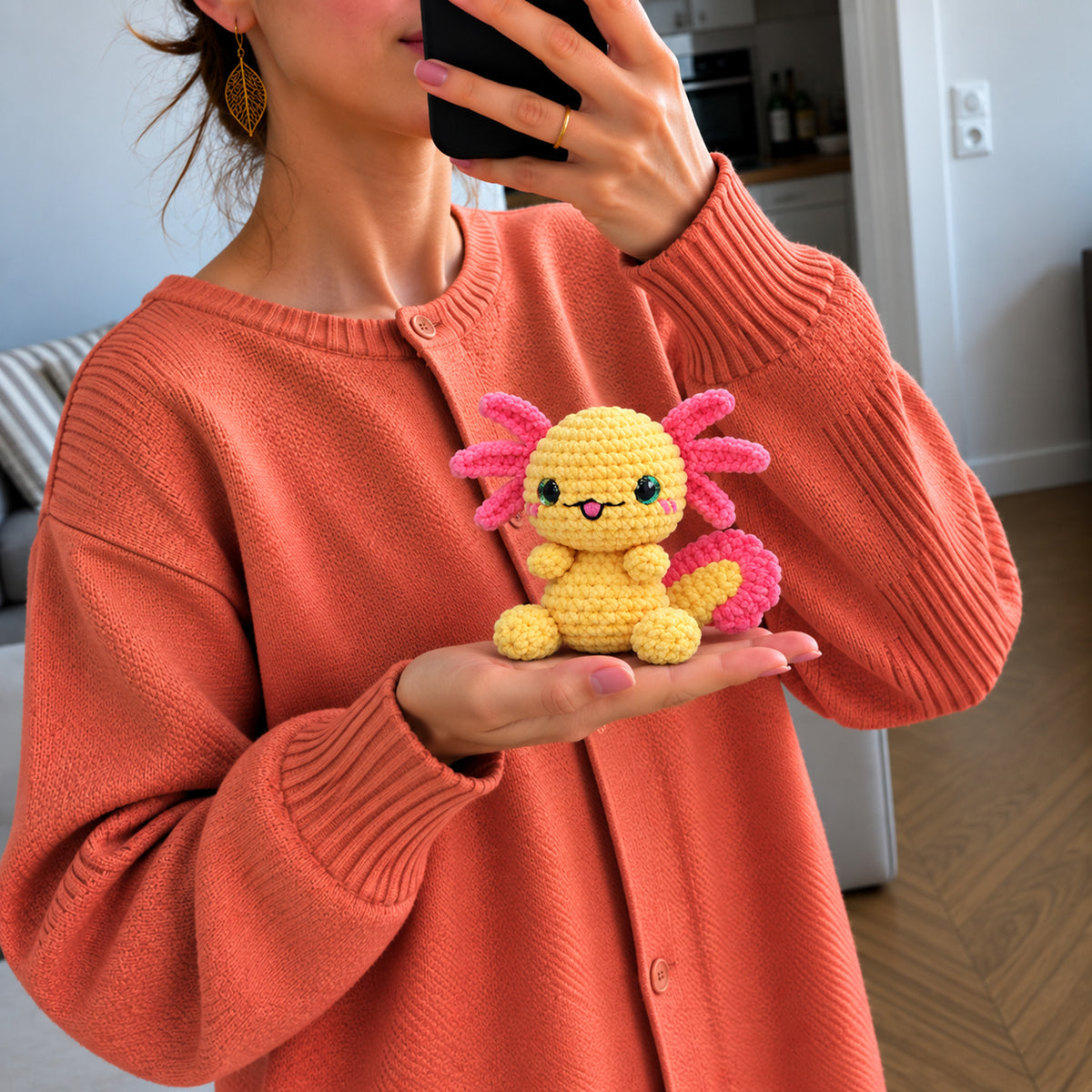 Sunbeam Axolotl: a yellow axolotl with pink gills and bright dark eyes, shown in hand