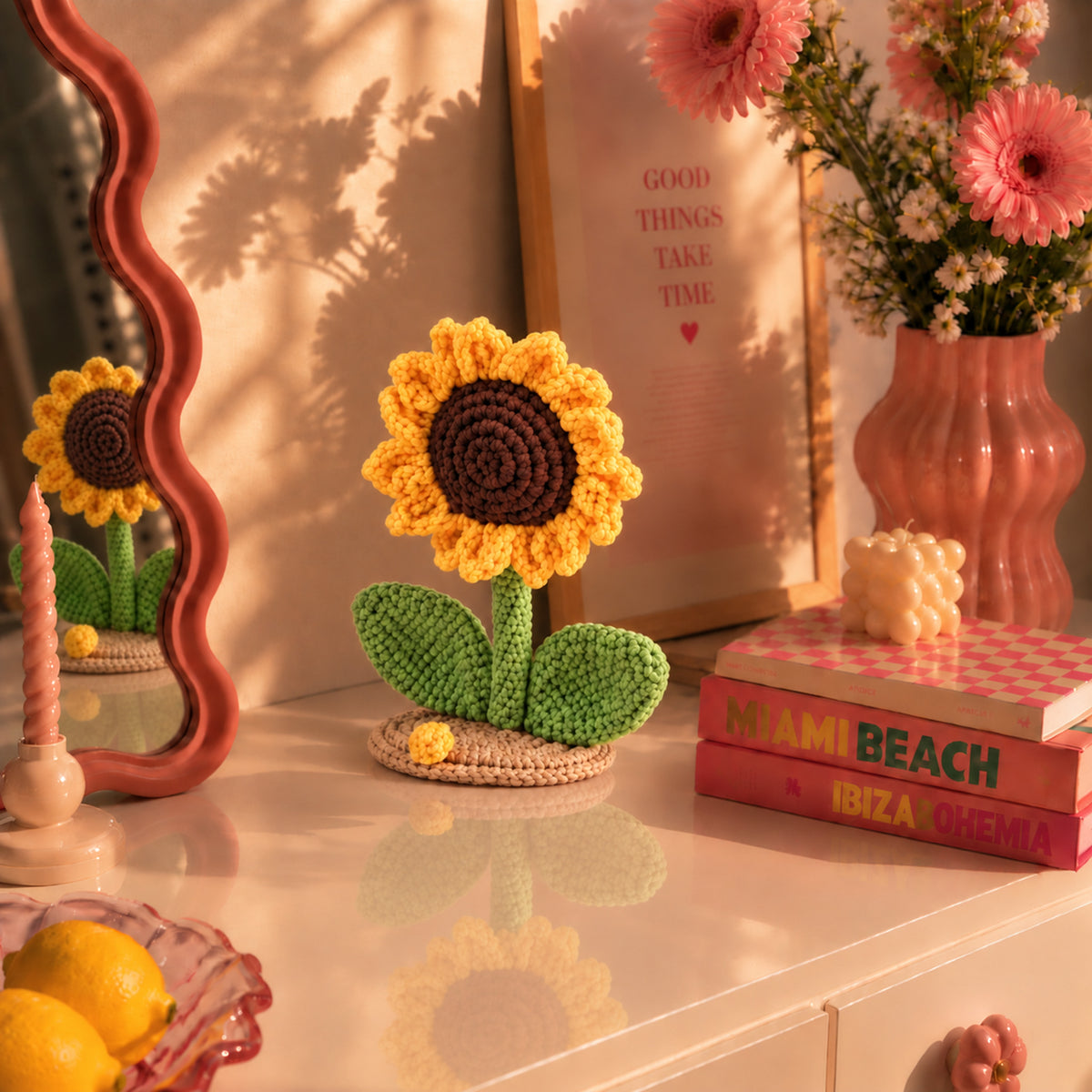 Sunflower Daydream: a golden sunflower with green leaves on a small base, displayed in an interior setting