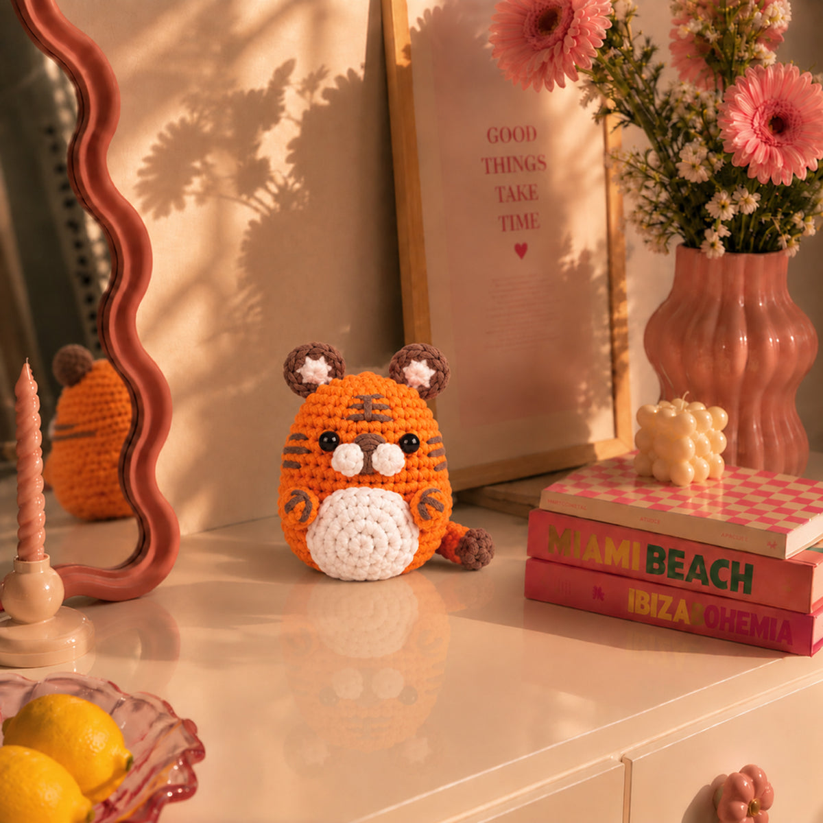 Tangerine Tiger: a bright orange tiger with dark stripes and rounded ears, displayed in an interior setting