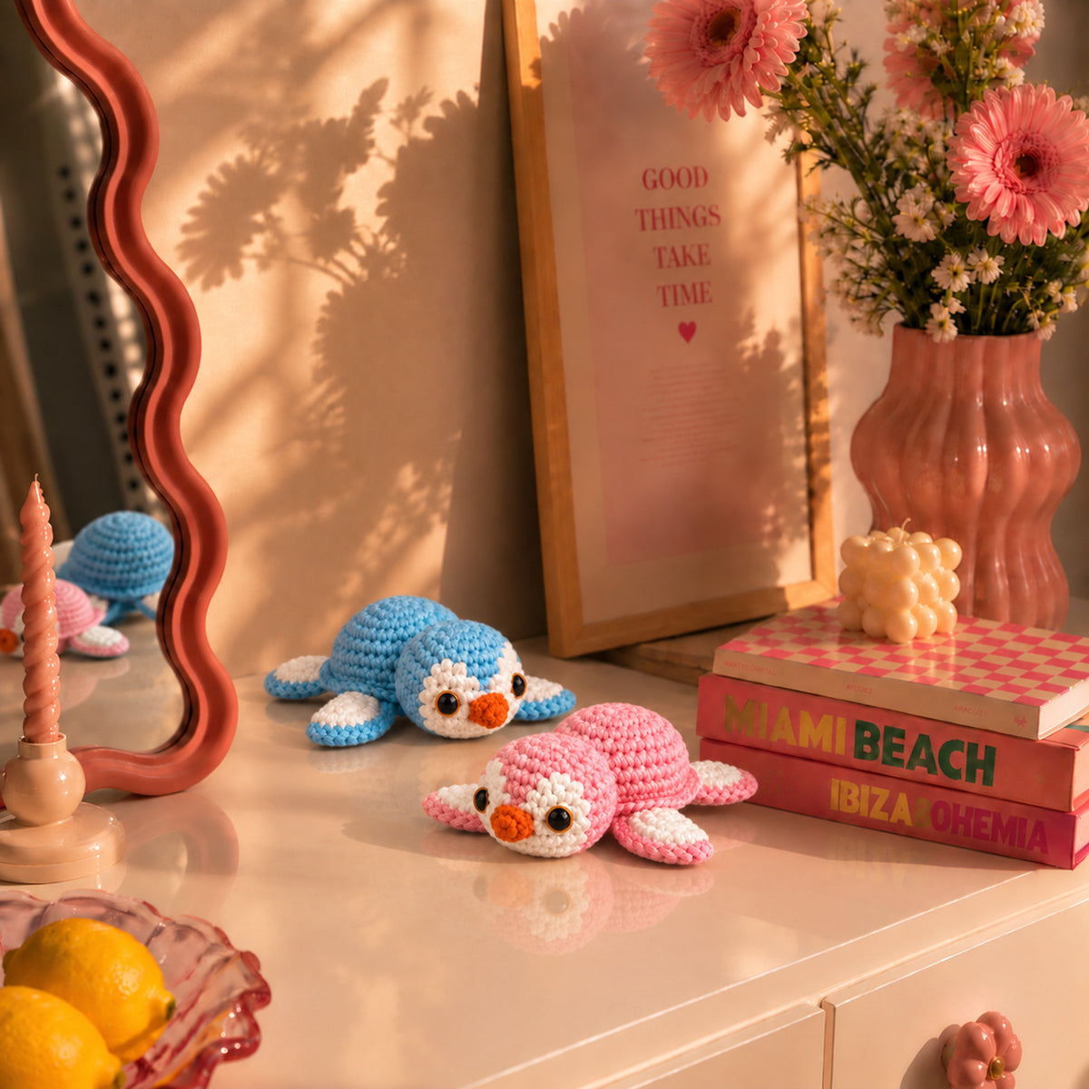Tidepool Turtle Pals: pink and blue sea turtles with tiny flower details, displayed in an interior setting