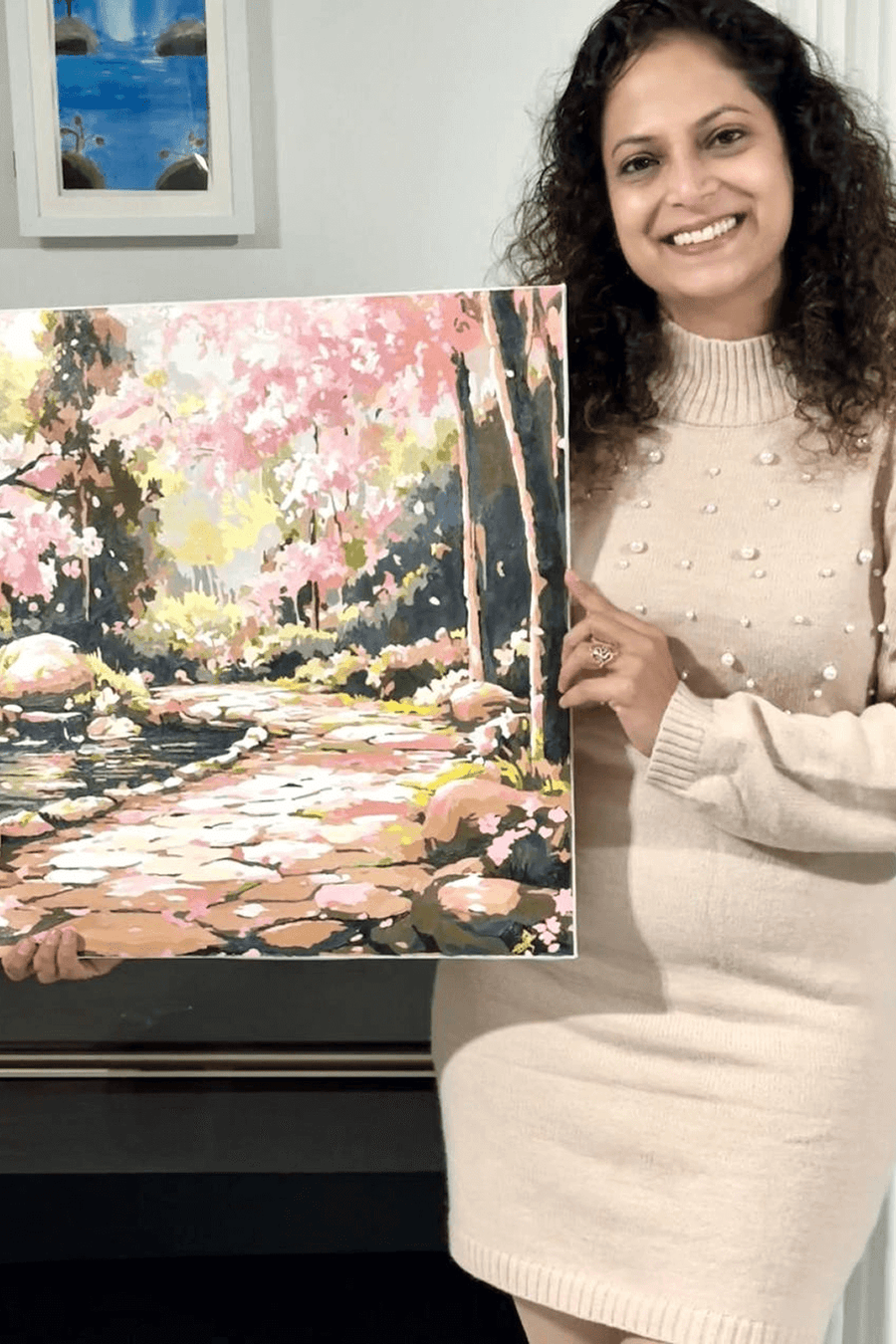 Painter holding a finished floral artwork