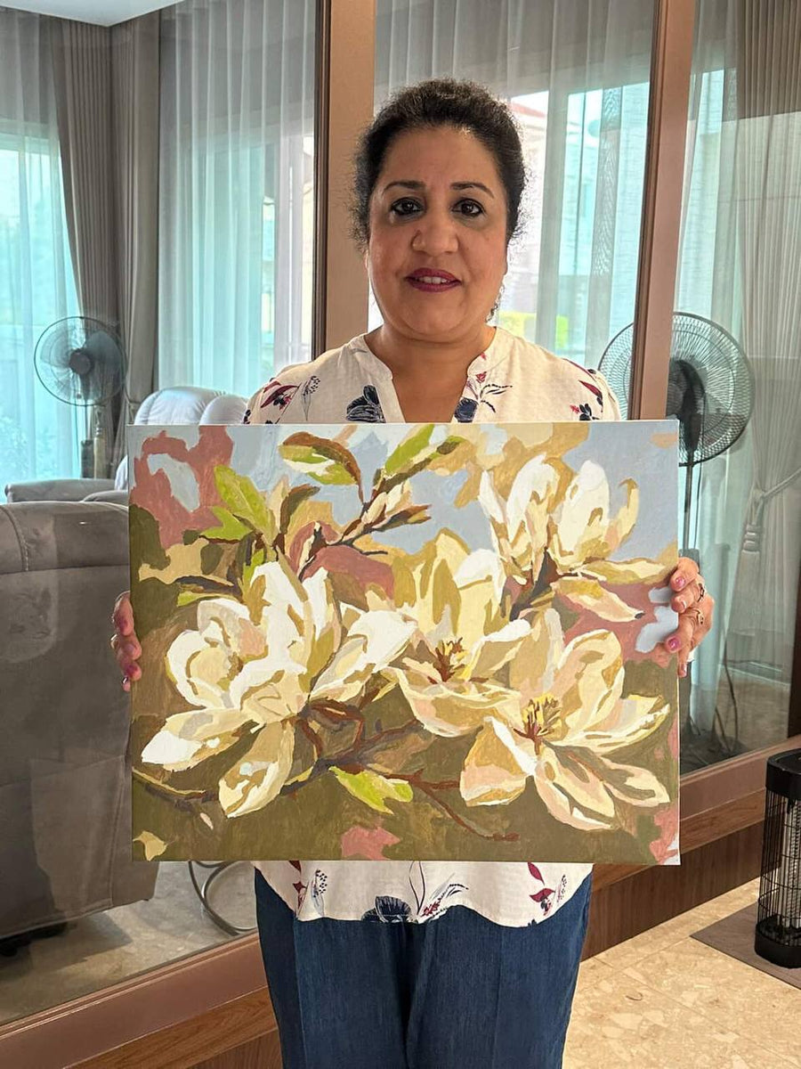 Painter presenting a large floral artwork
