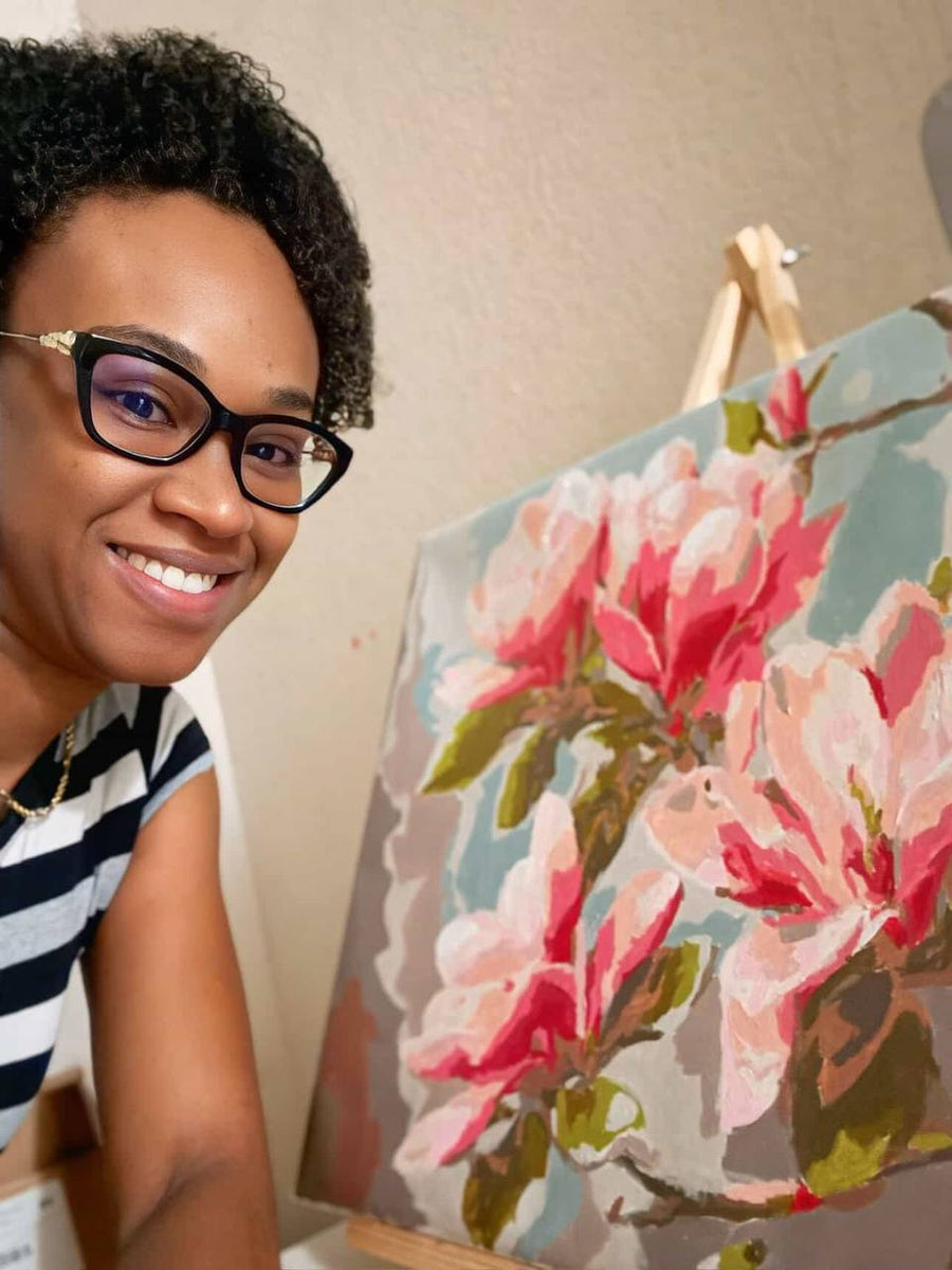 Painter holding a red floral artwork