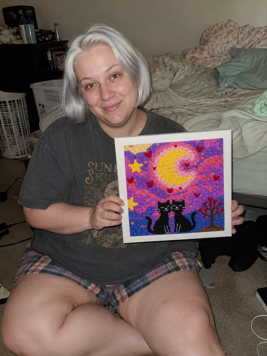 Painter holding a framed cat artwork